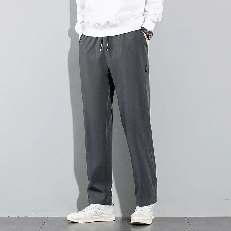 Pantalones de seda de hielo para hombre, novedad de verano 2025, negros, grises, finos, informales, de negocios, para exteriores, elásticos, transpirables, de pierna recta.