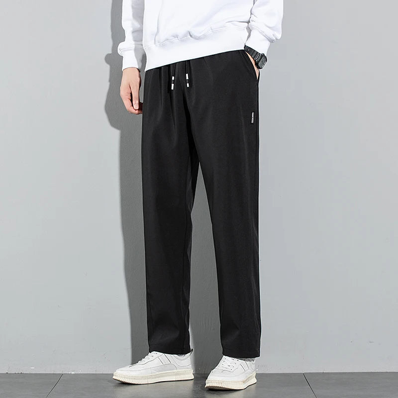 Pantalones de seda de hielo para hombre, novedad de verano 2025, negros, grises, finos, informales, de negocios, para exteriores, elásticos, transpirables, de pierna recta.