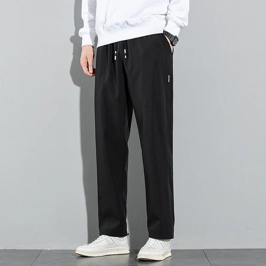 Pantalones de seda de hielo para hombre, novedad de verano 2025, negros, grises, finos, informales, de negocios, para exteriores, elásticos, transpirables, de pierna recta.