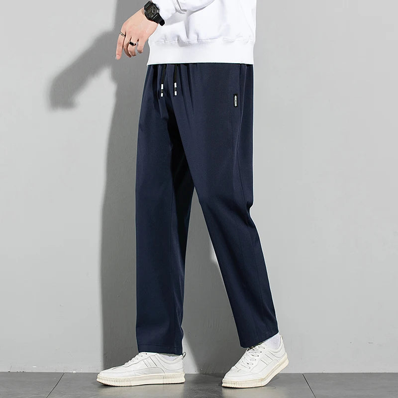 Pantalones de seda de hielo para hombre, novedad de verano 2025, negros, grises, finos, informales, de negocios, para exteriores, elásticos, transpirables, de pierna recta.